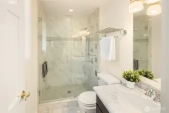 Upstairs, the generously sized primary suite features a beautifully remodeled ensuite bath with a spa-inspired shower.