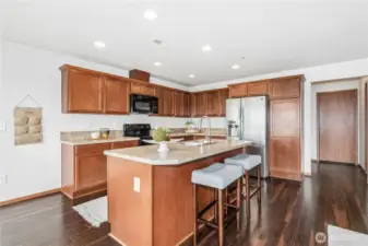 Open design kitchen with center island and wide plank floors
