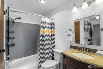 Updated bathroom has a lovely vanity and lights