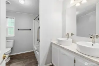 Large walk in shower with double sink vanity solid surface counter tops.