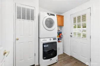 Laundry room located off the carpert.