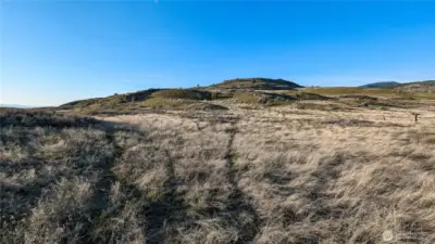 View looking North from the property center. Expansive horizons and multiple building sites. Easy access to Tonasket and Oroville.