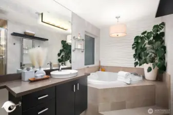 ...the luxurious primary suite bath with jetted soaking tub and separate shower...