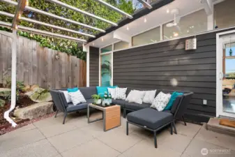 Another view of the covered area, with privacy hedge and fence.