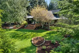 Large deck off the back of the house. Mature landscaping. This park like setting is calling your name!