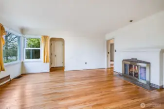 Living room gleams with stunning original hardwood floors!