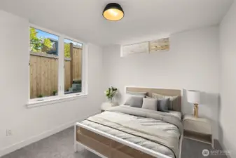 A secondary bedroom features plush carpet and ductless heating/cooling—perfect for peaceful mornings.
