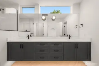 A peek into the luxe en suite bath—dual sinks, matte black hardware, and elegant finishes for a spa-like experience.