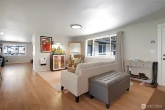 Open space living room off kitchen and front door to right.