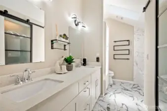 Brand-new spa inspired primary bath with heated floor and heated towel rack.