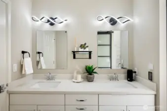 Dual sink vanity with designer light fixtures in the primary bath.