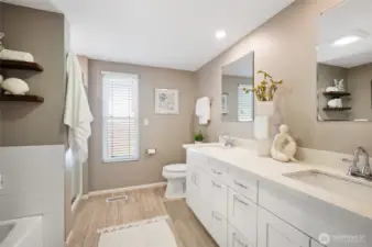 Remodeled full bath on lower level with dual sink vanity, soaking tub, and separate shower.
