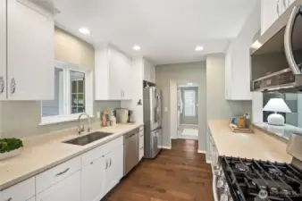 Stainless steel appliances, gas stove, and beautiful Quartz countertops.