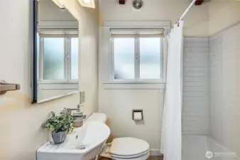 Full bath with heated tile floor and new cast iron bathtub.