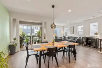 Sunlight pours in through dramatic high ceilings and expansive windows, creating a bright, airy ambiance.