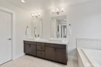 Indulge in your primary bathroom's luxurious amenities, featuring a soaking tub, spacious shower, and double sinks