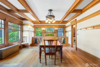 Beautiful built-ins are surrounded by windows and nature outside in the formal dining room.
