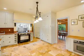 Spacious kitchen is the center of the home; between the formal dining, informal family room, directly from the entrance or outside through the sunroom.