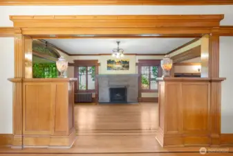 Formal living room is a showstopper, with very cool lighting (some original), light wood moulding (golden moulding!), and a large fireplace as an anchor.