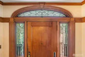 Original details, like this decorative glass surrounding the front door, showcase a time when quality was forever.