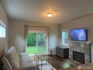 Sliding glass door that goes out to fenced backyard with patio