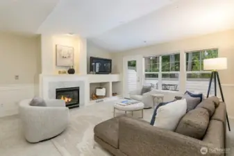 Living room features vaulted ceilings, gas-burning fireplace and access to the deck.