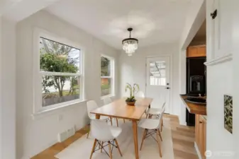 Virtually staged dining area with new chandelier