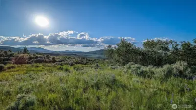 Positioned within the natural beauty of the Aspen grove, this NW-facing vantage point offers sweeping vistas and cooling summer breezes.
