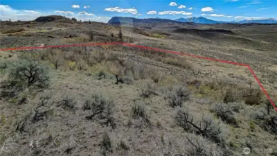 Unmatched western exposure from the property’s high point. This view from the eastern hillside captures the vast beauty of Okanogan County. Perfect for a home designed to take in the late-day sun. Boundary lines are approximate per county data; not a formal survey.