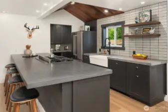 Expansive kitchen bar with hand poured countertops