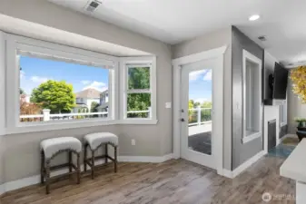 Area off the kitchen perfect for another table and door to wraparound deck