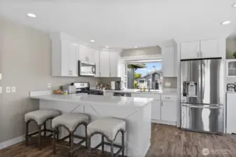 Kitchen with quartz countertops with door to the wraparound deck