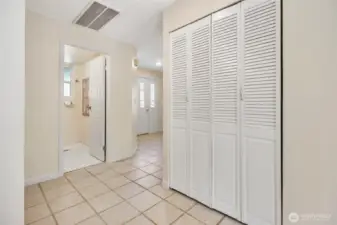 A view of the entry hall, powder room and laundry area.
