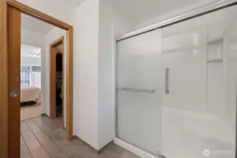Nice walk-in shower with bench for comfort.