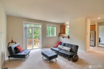 Slider off the family room leads to the deck, patio and fully fenced back yard. You can also see the passthrough to the kitchen and breakfast bar. Off to the far right is the entry to the formal dining room.