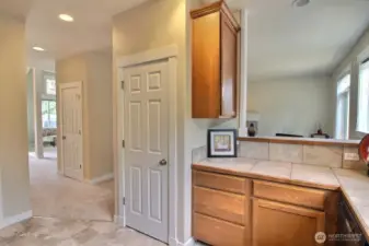 Great use of space with tons of cabinets and pantry right in the kitchen! Stylish tile counters and backsplash add to the refined extras in this home. Nice view of the floorplan as you can see back into the living room.