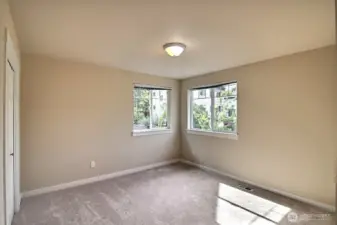 Located in the front of the home is one of the two additional bedroom. These two corner windows really light up this room!