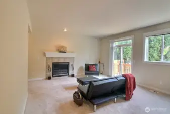 Sizable Family room with a cozy fireplace and crisp white mantle.