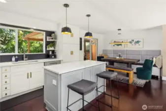This stylish dining nook features custom built-in bench seating, a rustic wood table, and plush velvet chairs for a cozy yet modern vibe. Sliding glass doors open to a covered patio, extending your entertaining space outdoors. A perfect blend of comfort and function.