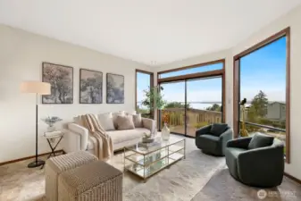 Formal dining & living facing Western Sound & Mountain Views, opening to deck