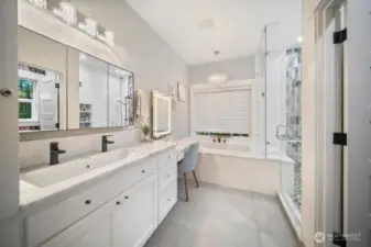 Primary Bath with dual faucets and a vanity table.  Deep Soaking Tub, Heated Tile Floors, and a Shower built for Two! Owner has plumbing stub for 2nd sink, and there is a pull out ironing center in the walk in closet. The bathroom is compartmented with heated bidet.