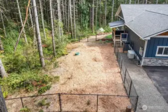 The dog yard with waste composter cistern installed to keep the whole area clean. This area is accessed from the main floor laundry room.  The covered area gives the dogs a place to get dry before coming back into the house.  The laundry room is extra big for an installation of a tub for a tub for giving your pet a bath. The area has been plumbed and ready for your choice of tub.