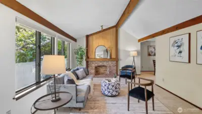 Enjoy this Sun-filled space framed by large windows and cozy brick fireplace.
