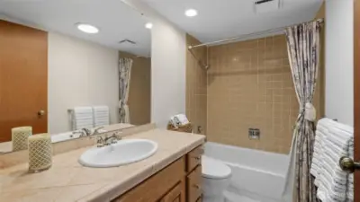 Spacious secondary bathroom upstairs with tub and shower combo and plenty of counter space.