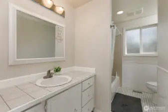 Main full bathroom with storage space and new paint!