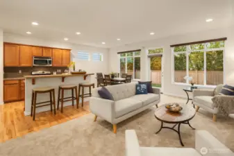 Great main floor layout with new carpet and wall of windows looking out to your private backyard.