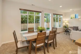 Dining area with private backyard view.