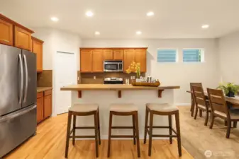 Kitchen has stainless steel appliances and additional island seating.