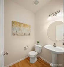 Main floor half bath is easily accessible, and next to interior door to the garage.