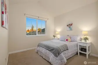 Second bedroom facing east with vaulted ceilings.